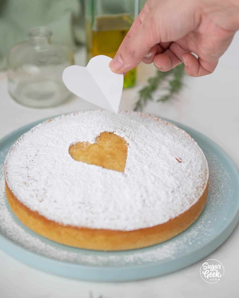 lifting a paper heart off a cake