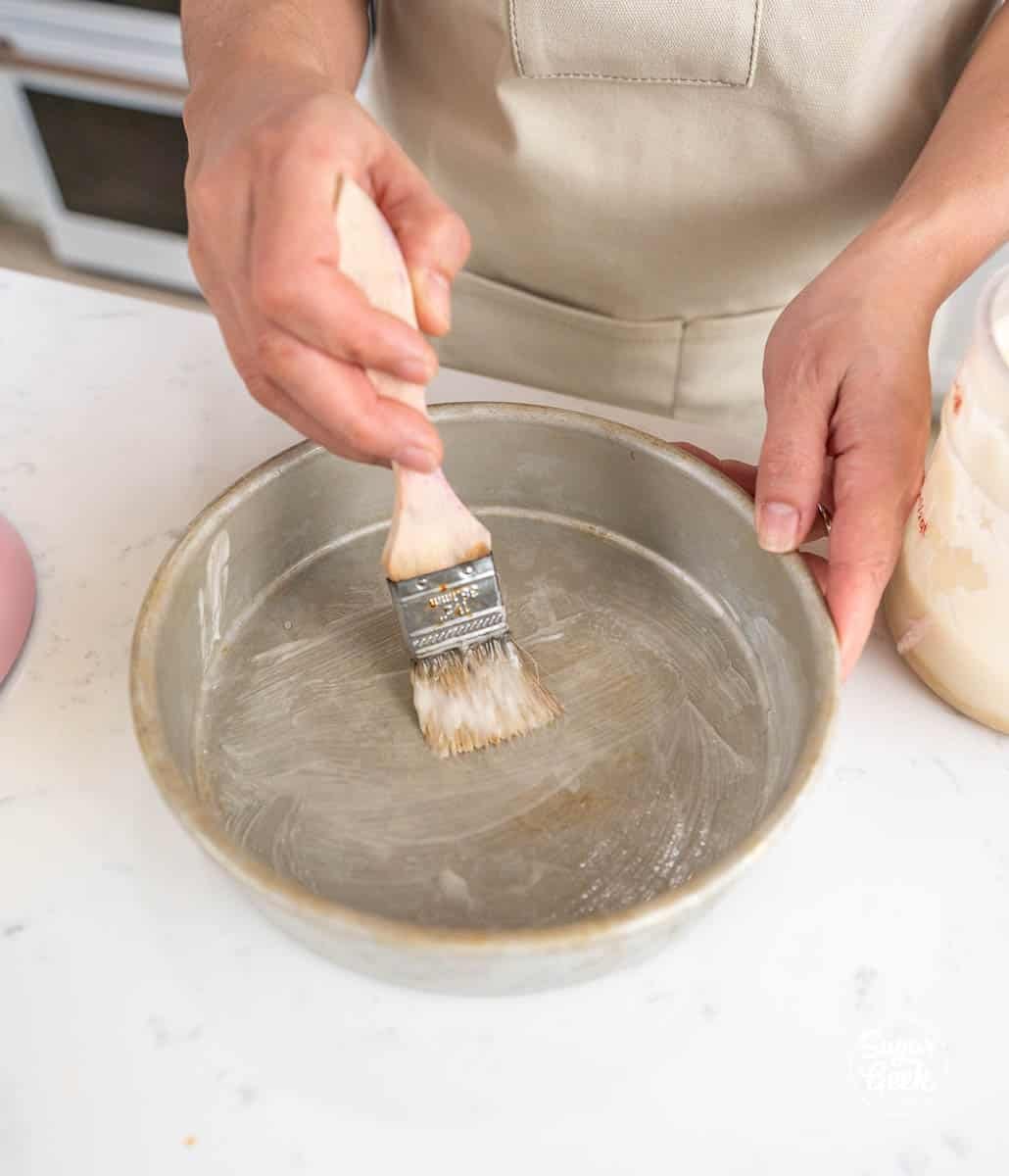 coating a pan with cake goop