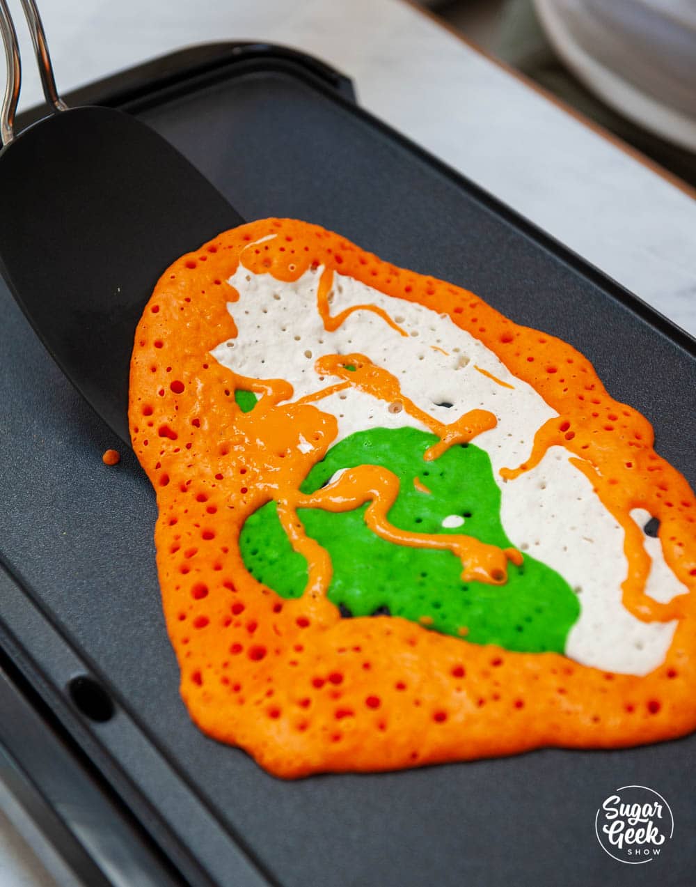 cooking pancake art on a griddle