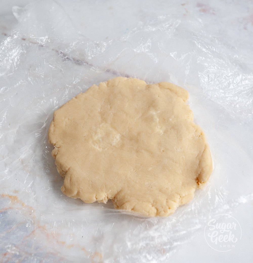 tart dough on plastic wrap on a white background