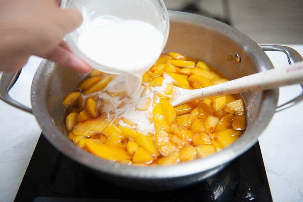adding cornstarch slurry to peach filling