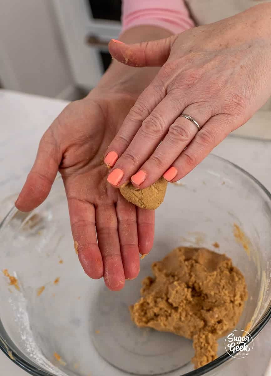 Hands rolling peanut butter filling mixture into a ball