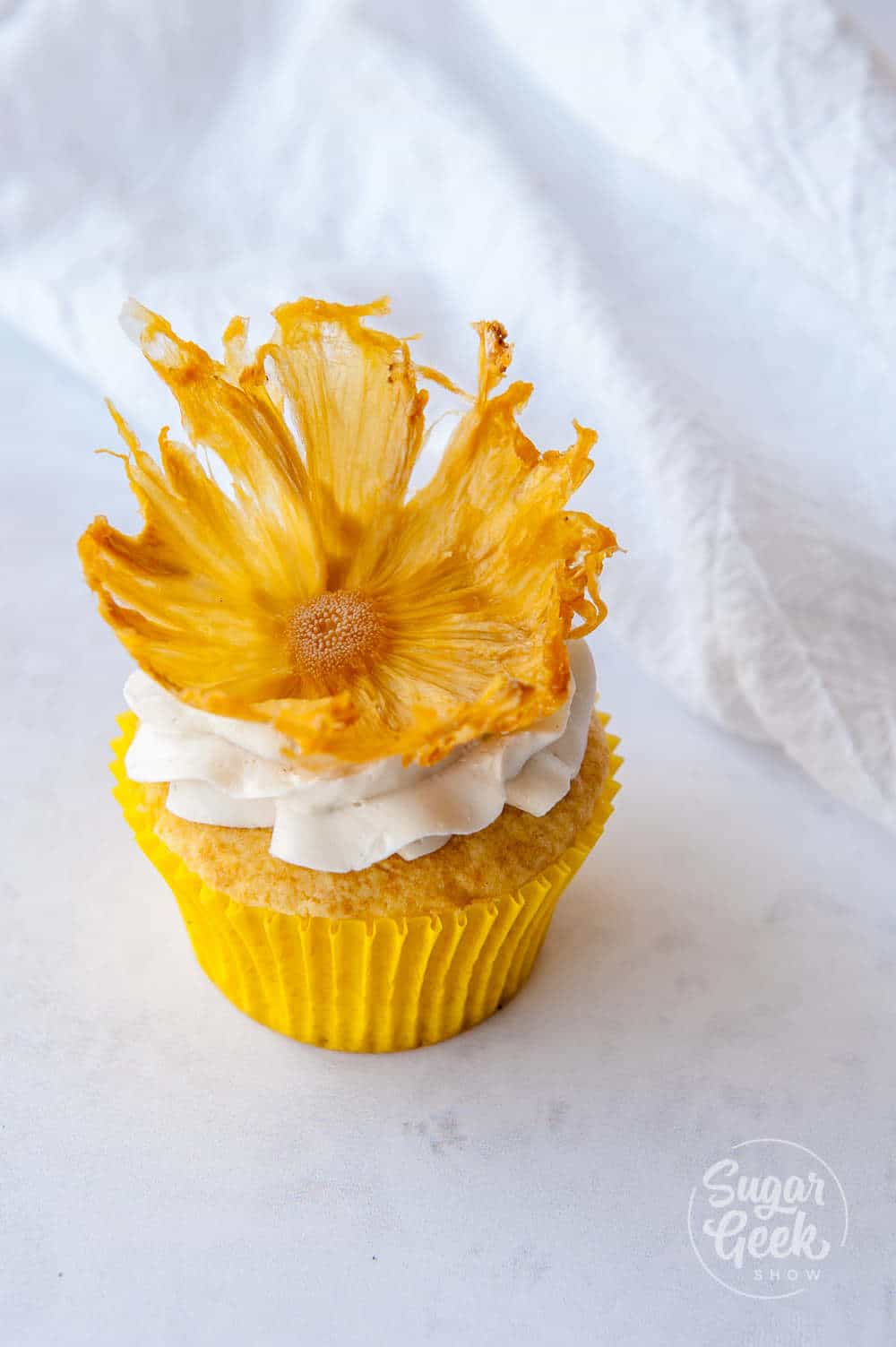 dried pineapple flower on cupcake