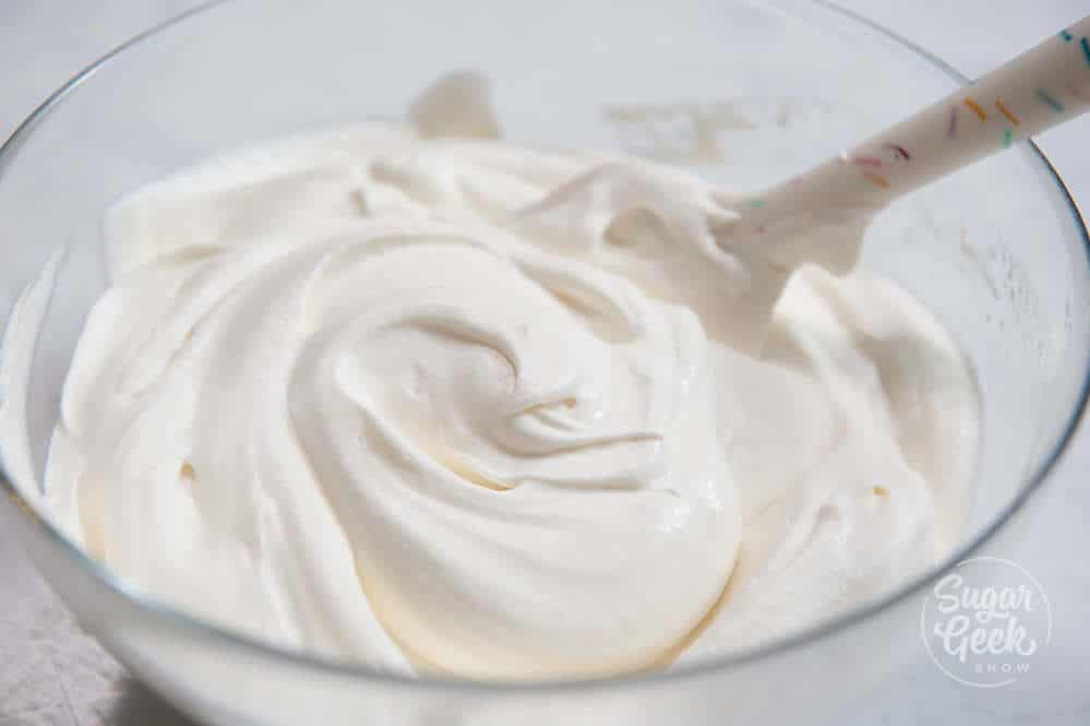 close up of stabilized whipped cream in a clear bowl
