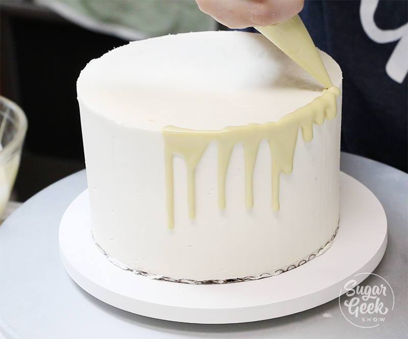 how to pour white chocolate ganache drip onto a cake