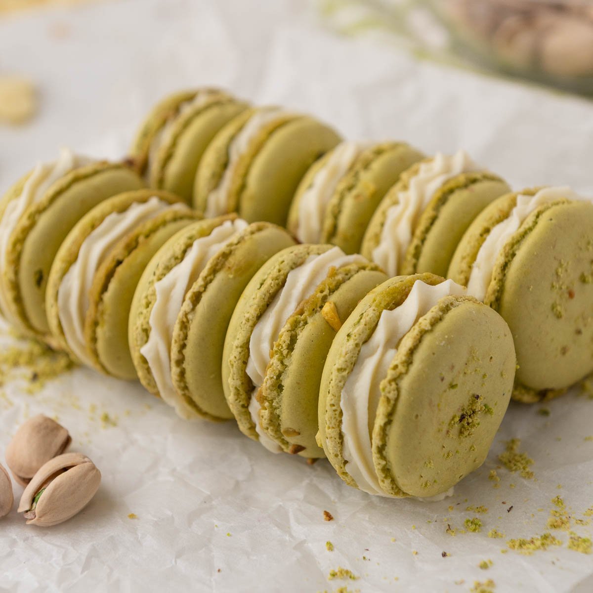 pistachio macarons stacked and laying down
