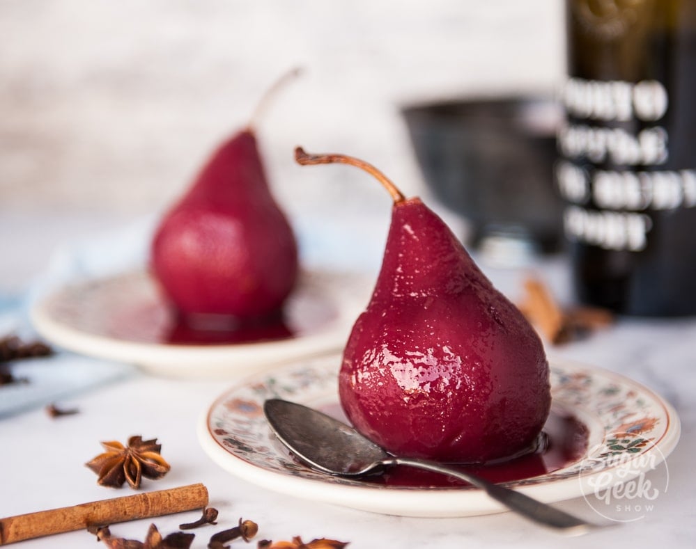 poached pears in red wine on a plate with spices