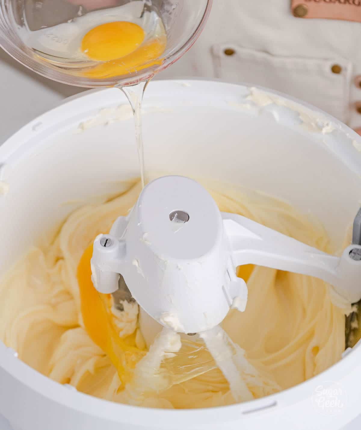 bowl of eggs being poured into a stand mixer