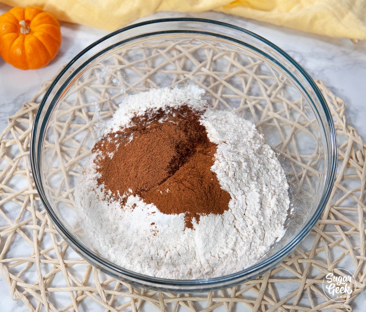 pumpkin spice cake ingredients in a clear bowl
