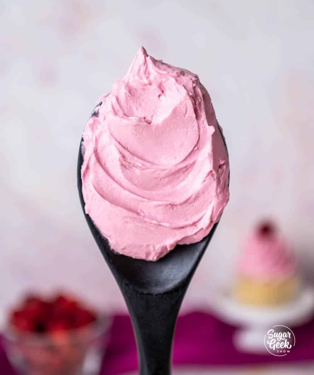 black spoon filled with raspberry buttercream