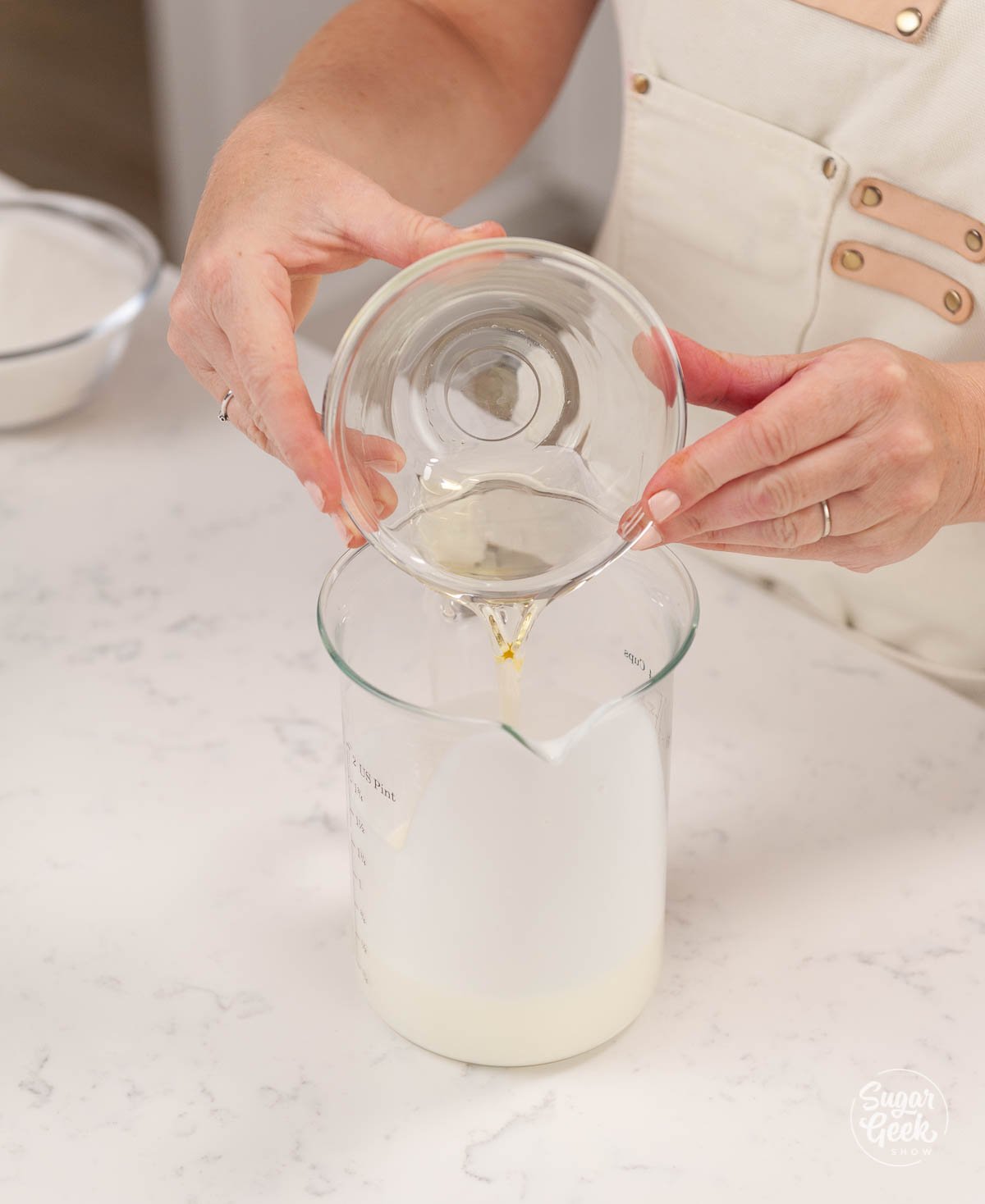 combining milk with oil in a measuring cup