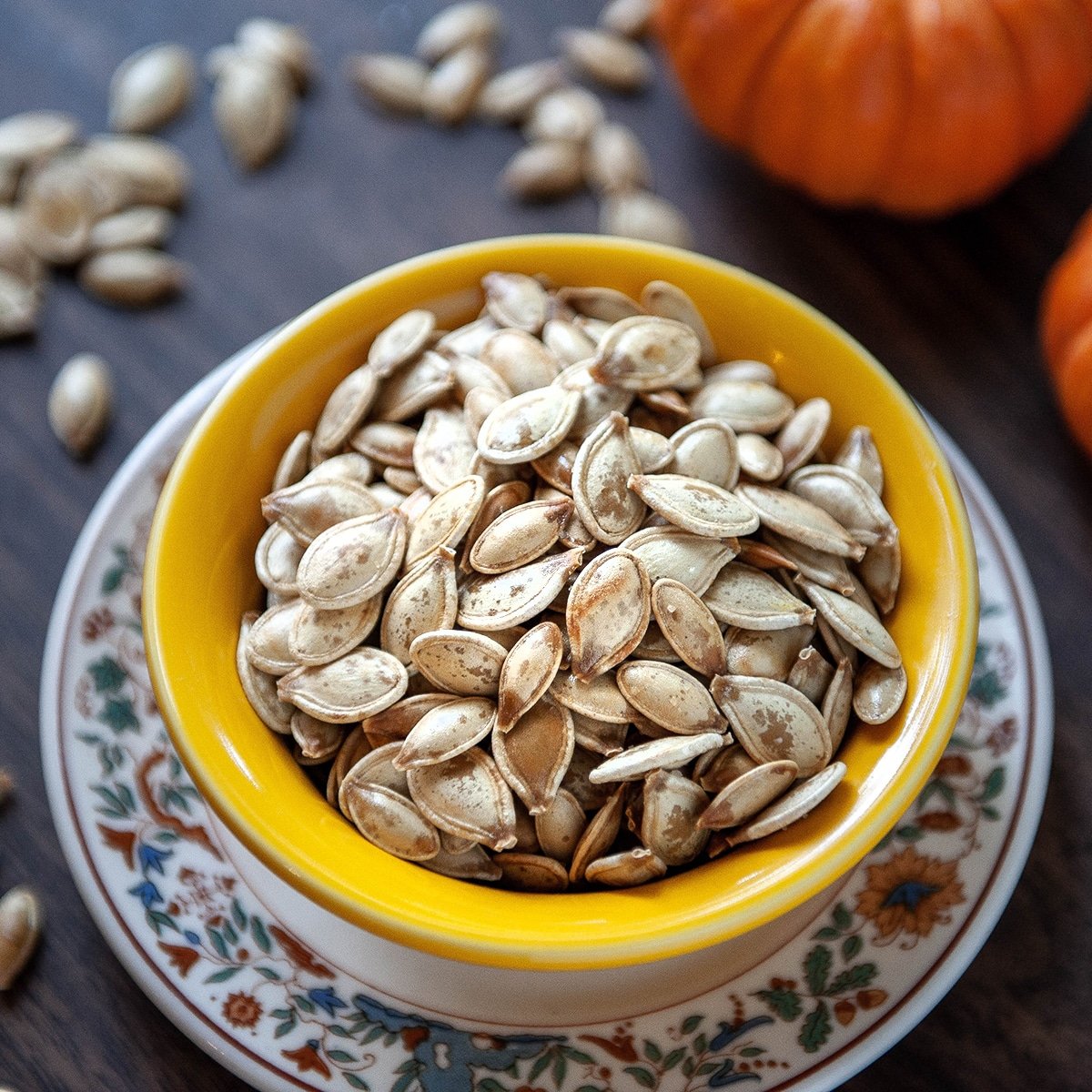 roasted pumpkin seeds in a yellow bowl