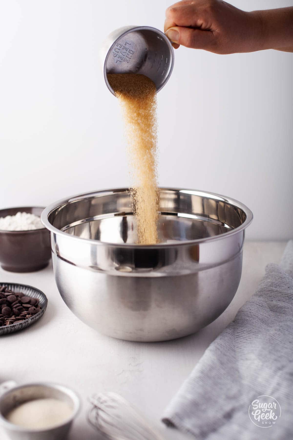 pouring brown sugar into a bowl