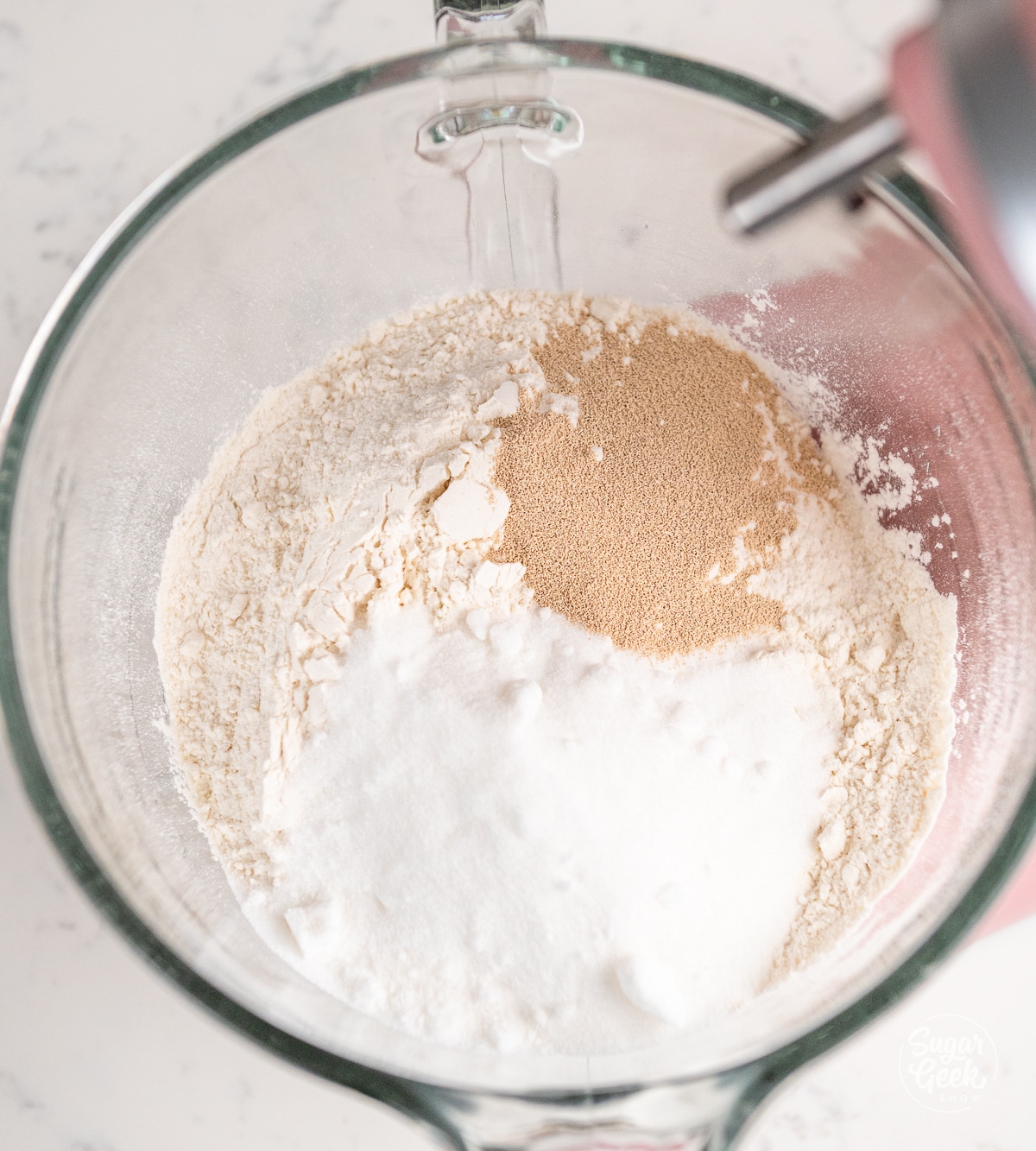 dry ingredients for sticky buns in a glass stand mixer bowl