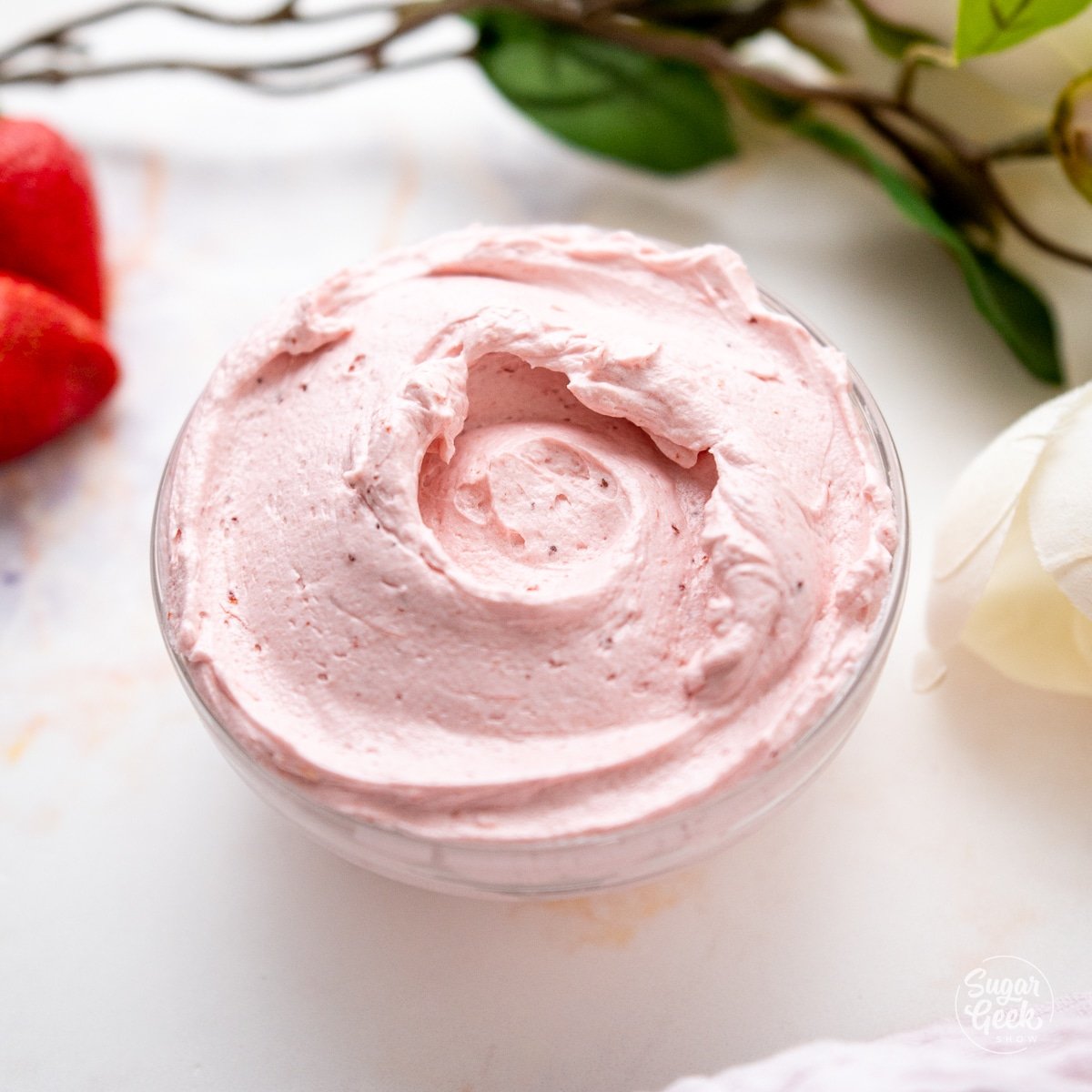 clear bowl filled with strawberry buttercream
