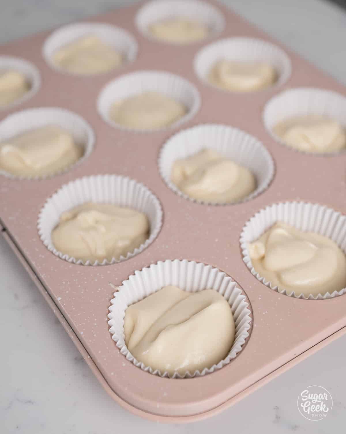 Cupcake pan with filled cupcake liners ready to bake.